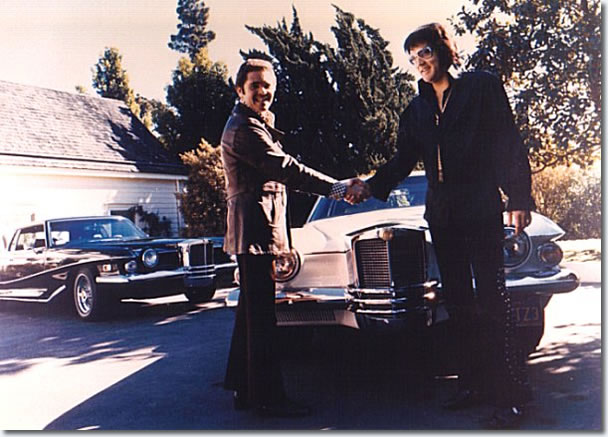 Elvis Presley accepting keys for his Pearl White Stutz Blackhawk from salesman Jules Meyers in late September / early October 1973